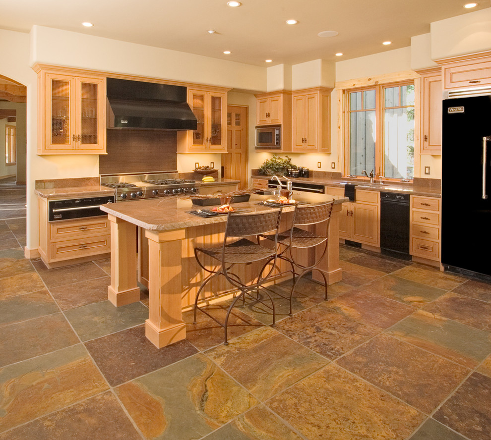 Eat-in kitchen - mid-sized rustic l-shaped travertine floor eat-in kitchen idea in Albuquerque with a double-bowl sink, glass-front cabinets, medium tone wood cabinets, granite countertops, brown backsplash and an island