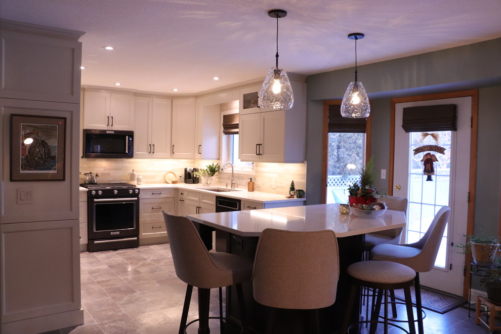 Small traditional u-shaped kitchen/diner in Edmonton with a submerged sink, shaker cabinets, white cabinets, engineered stone countertops, beige splashback, ceramic splashback, stainless steel appliances, lino flooring, an island, beige floors and yellow worktops.
