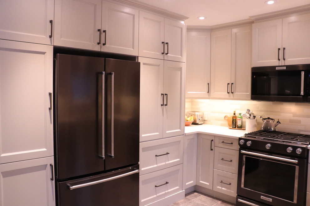 Example of a small transitional u-shaped linoleum floor and beige floor eat-in kitchen design in Edmonton with an undermount sink, shaker cabinets, white cabinets, quartz countertops, beige backsplash, ceramic backsplash, stainless steel appliances, an island and yellow countertops