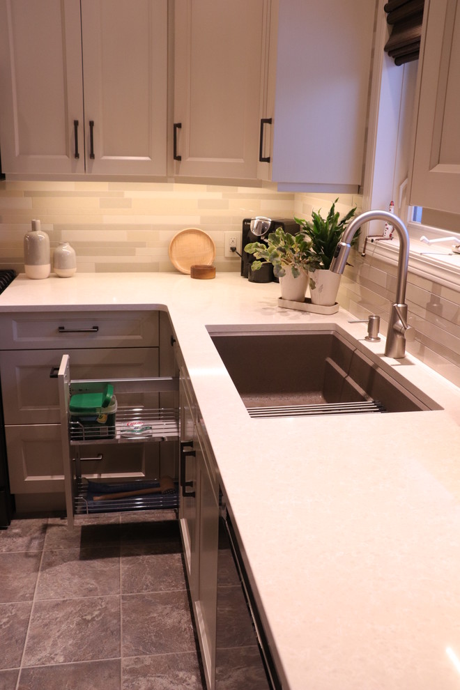 Inspiration for a small traditional u-shaped kitchen/diner in Edmonton with a submerged sink, shaker cabinets, white cabinets, engineered stone countertops, beige splashback, ceramic splashback, stainless steel appliances, lino flooring, an island, beige floors and yellow worktops.