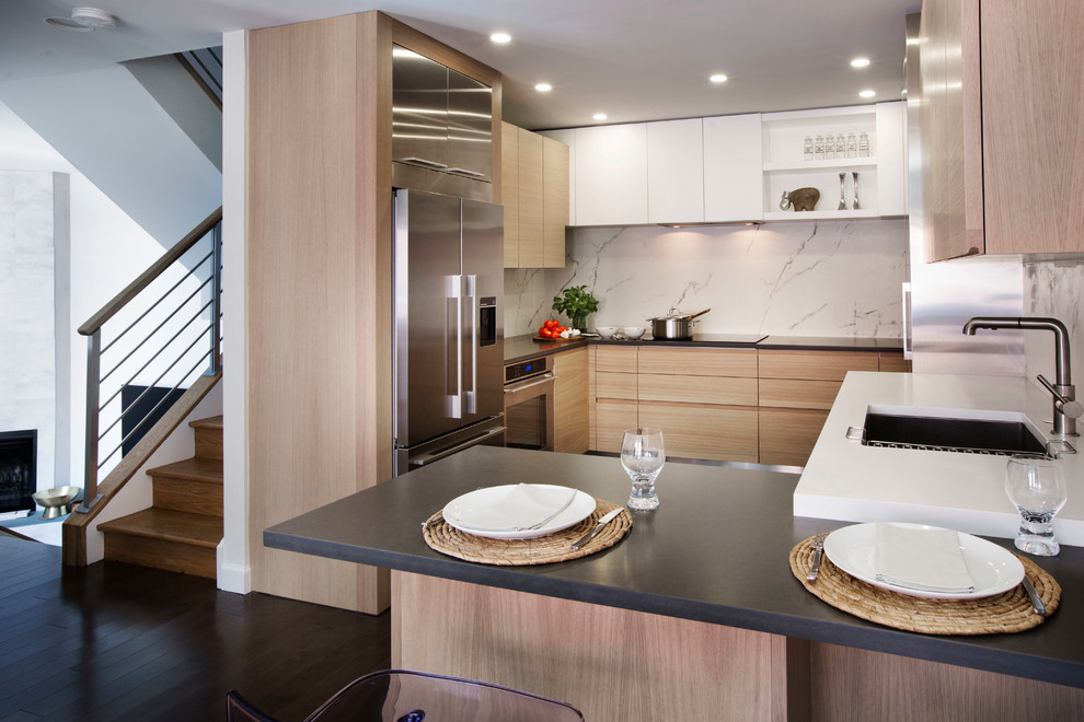 Eat-in kitchen - mid-sized contemporary l-shaped medium tone wood floor and brown floor eat-in kitchen idea in Philadelphia with an undermount sink, flat-panel cabinets, light wood cabinets, quartz countertops, white backsplash, marble backsplash, stainless steel appliances and a peninsula