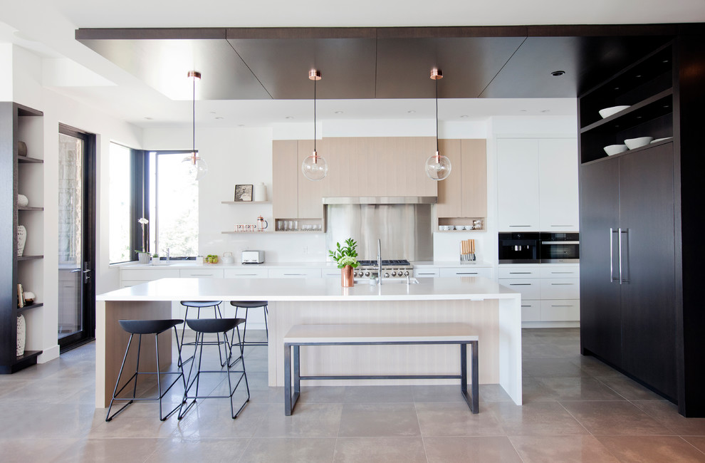 Inspiration for a large contemporary porcelain tile open concept kitchen remodel in Vancouver with an undermount sink, flat-panel cabinets, light wood cabinets, quartz countertops, white backsplash, stone slab backsplash, paneled appliances and an island