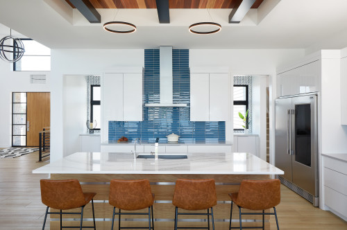 Glossy Delight: Achieve a Stylish Look with a Glossy Blue Backsplash and White Cabinetry