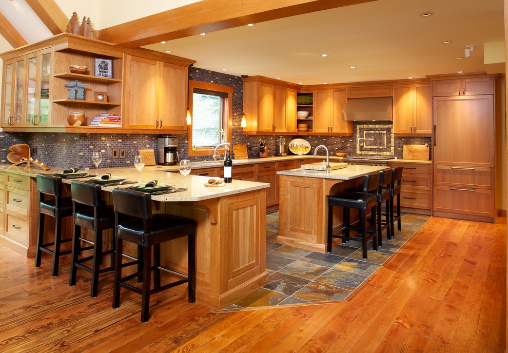 Example of a large trendy u-shaped slate floor and multicolored floor kitchen design in Vancouver with shaker cabinets, light wood cabinets, granite countertops, gray backsplash, matchstick tile backsplash, paneled appliances, an island and an undermount sink