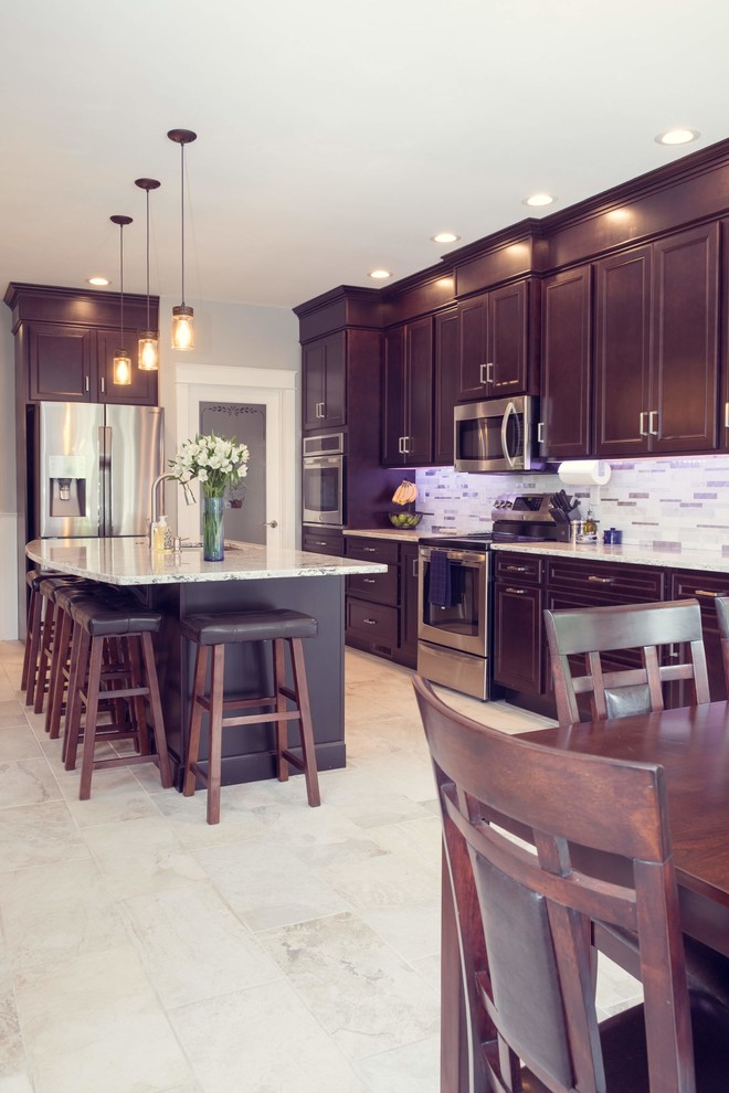 Elegant single-wall white floor and porcelain tile eat-in kitchen photo in Cedar Rapids with an undermount sink, recessed-panel cabinets, dark wood cabinets, quartz countertops, metallic backsplash, mosaic tile backsplash, stainless steel appliances, an island and white countertops