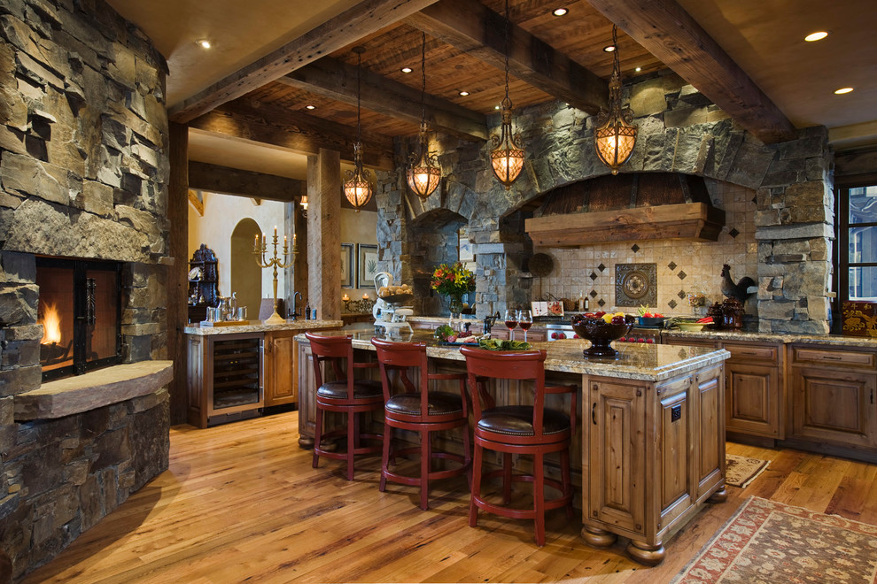 Mountain style kitchen photo in Other with raised-panel cabinets, medium tone wood cabinets, beige backsplash and stainless steel appliances