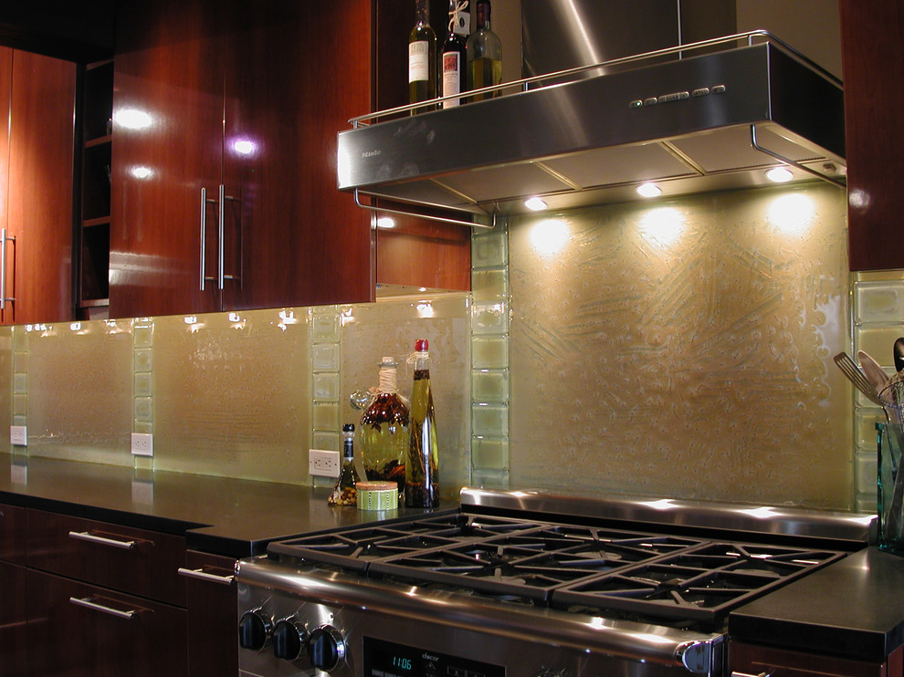 Inspiration for an eclectic kitchen remodel in Seattle with glass countertops and glass sheet backsplash