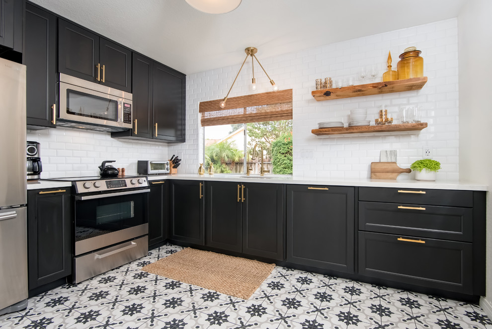 Inspiration for a mid-sized contemporary l-shaped porcelain tile and white floor enclosed kitchen remodel in Los Angeles with an undermount sink, shaker cabinets, black cabinets, quartz countertops, white backsplash, subway tile backsplash, stainless steel appliances and no island