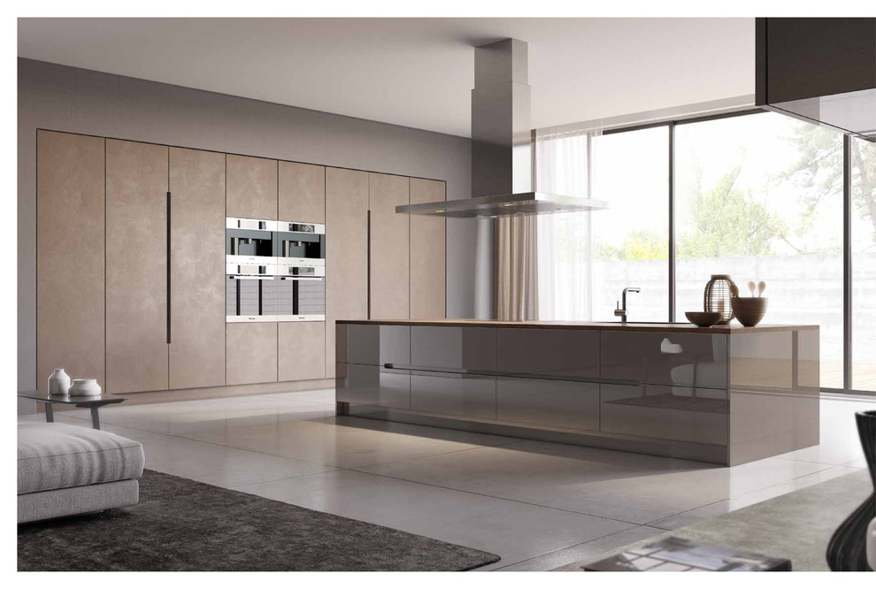 This is an example of an expansive modern single-wall open plan kitchen in London with an integrated sink, flat-panel cabinets, beige cabinets, concrete worktops, beige splashback, integrated appliances, porcelain flooring and an island.