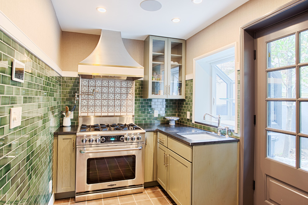 Inspiration for a mid-sized contemporary l-shaped concrete floor enclosed kitchen remodel in Philadelphia with an undermount sink, flat-panel cabinets, green cabinets, green backsplash, subway tile backsplash, stainless steel appliances, no island and granite countertops