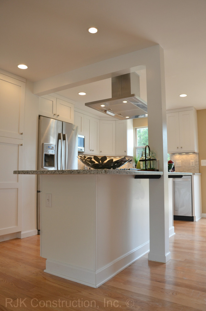 Inspiration for a huge transitional l-shaped light wood floor open concept kitchen remodel in DC Metro with an undermount sink, shaker cabinets, white cabinets, granite countertops, gray backsplash, ceramic backsplash, stainless steel appliances and an island