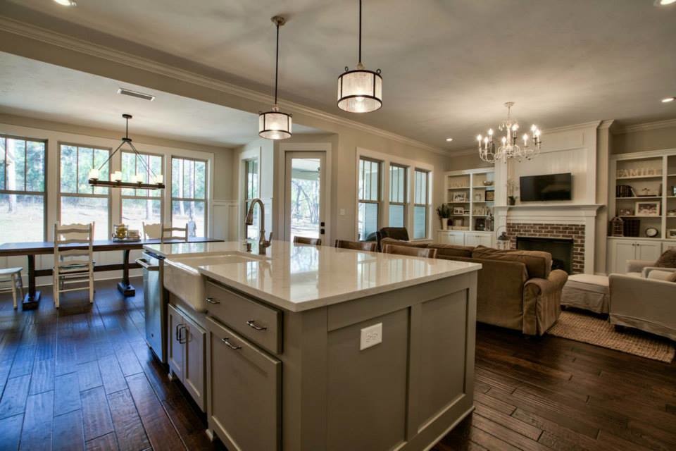 Inspiration for a large coastal l-shaped medium tone wood floor open concept kitchen remodel in Atlanta with a farmhouse sink, shaker cabinets, gray cabinets, marble countertops, white backsplash, subway tile backsplash, stainless steel appliances and an island