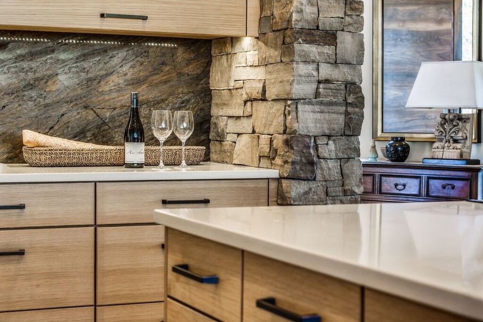 Photo of a medium sized rustic u-shaped open plan kitchen in Other with a submerged sink, flat-panel cabinets, light wood cabinets, composite countertops, brown splashback, stone slab splashback, coloured appliances, travertine flooring and an island.