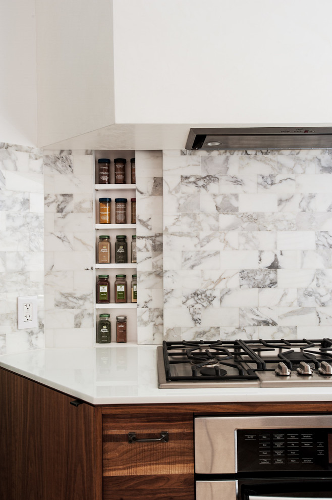 Open concept kitchen - mid-sized contemporary u-shaped open concept kitchen idea in New York with medium tone wood cabinets, multicolored backsplash, stainless steel appliances, flat-panel cabinets and marble backsplash