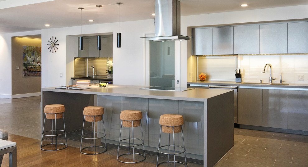 Mid-sized trendy l-shaped porcelain tile eat-in kitchen photo in Los Angeles with a double-bowl sink, glass-front cabinets, gray cabinets, solid surface countertops, white backsplash, stone slab backsplash, white appliances and an island