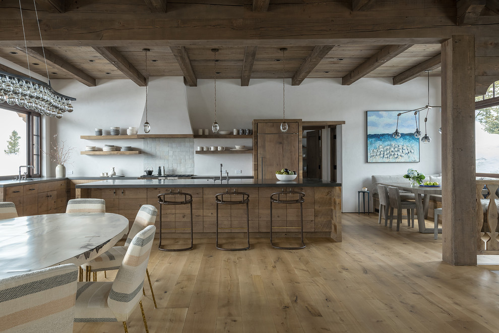 Photo of a rustic l-shaped kitchen/diner in Other with a submerged sink, flat-panel cabinets, medium wood cabinets, grey splashback, mosaic tiled splashback, integrated appliances, light hardwood flooring, an island, beige floors and grey worktops.