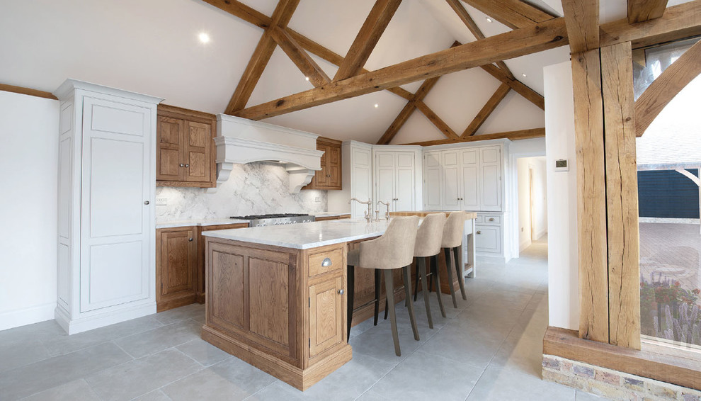 This is an example of a large classic l-shaped open plan kitchen with marble worktops, limestone flooring, an island and grey floors.
