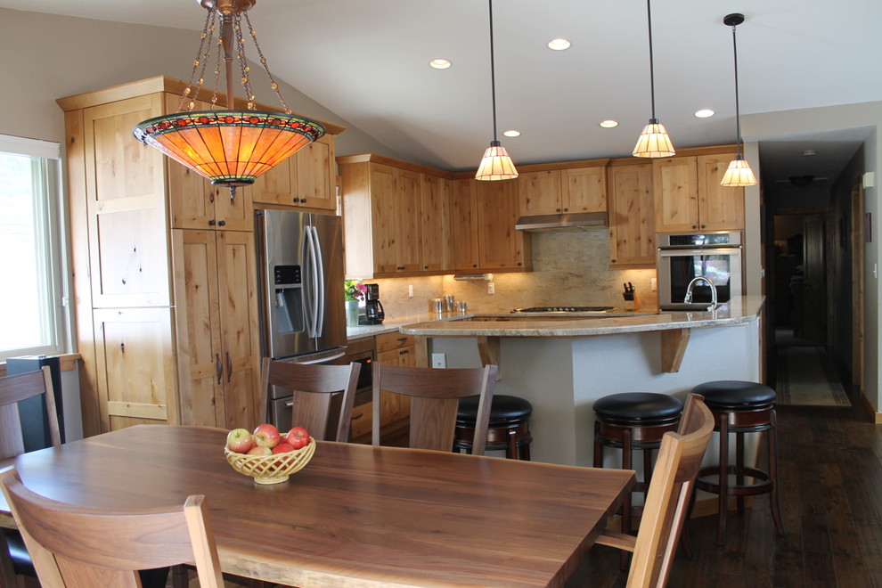 Inspiration for a large rustic l-shaped kitchen/diner in Denver with a submerged sink, flat-panel cabinets, light wood cabinets, granite worktops, beige splashback, stainless steel appliances, dark hardwood flooring and an island.