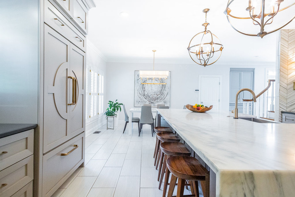 Large minimalist u-shaped porcelain tile and gray floor kitchen photo in Other with a farmhouse sink, gray cabinets, marble countertops, gray backsplash, marble backsplash, stainless steel appliances, an island and multicolored countertops