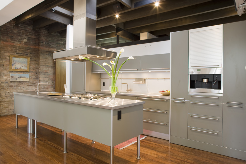 Modern galley kitchen in Philadelphia with stainless steel worktops, flat-panel cabinets and grey cabinets.