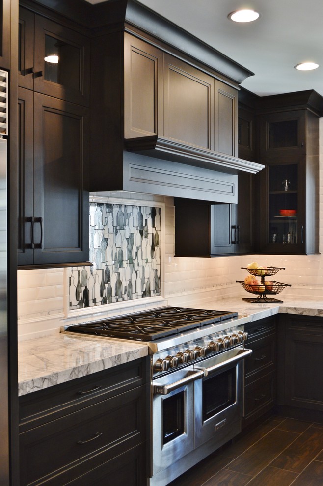 Large transitional l-shaped dark wood floor enclosed kitchen photo in DC Metro with an undermount sink, dark wood cabinets, white backsplash, subway tile backsplash, stainless steel appliances, two islands and shaker cabinets