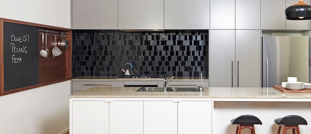 Photo of a contemporary kitchen in Brisbane with black splashback.