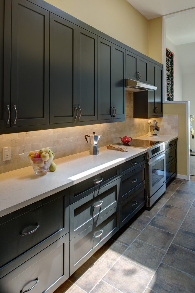 This is an example of a small modern galley kitchen pantry in San Francisco with shaker cabinets, grey cabinets, engineered stone countertops, beige splashback, porcelain splashback, stainless steel appliances, porcelain flooring and no island.