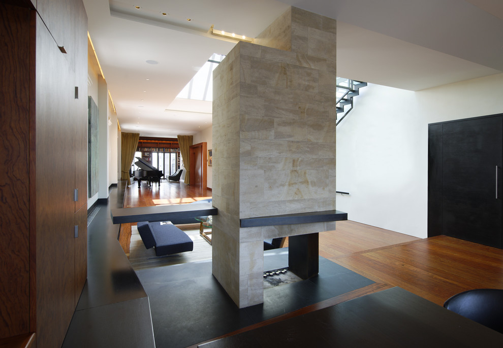 Example of a large trendy l-shaped medium tone wood floor eat-in kitchen design in New York with flat-panel cabinets, medium tone wood cabinets, stainless steel appliances and an island
