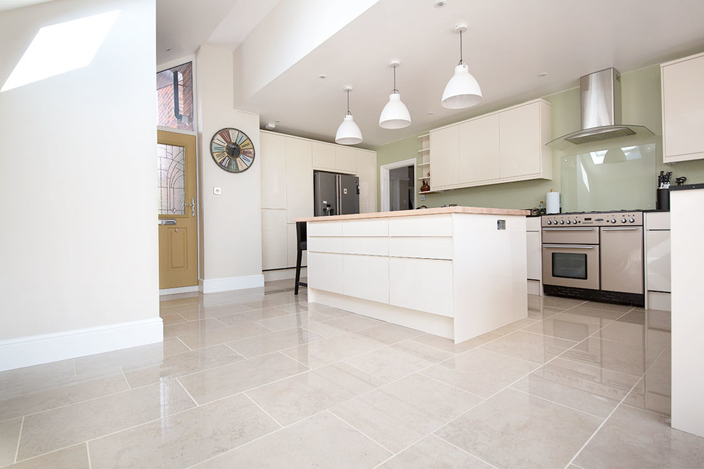 Mid-sized contemporary u-shaped open plan kitchen in Other with limestone floors, with island and grey floor.