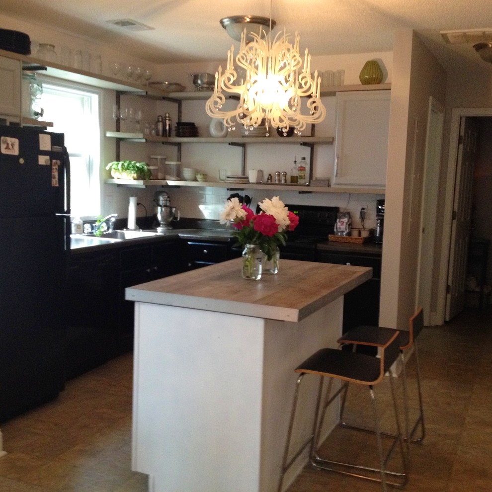 Small urban l-shaped eat-in kitchen photo in Raleigh with a single-bowl sink, black cabinets, tile countertops, white backsplash, subway tile backsplash, black appliances and an island