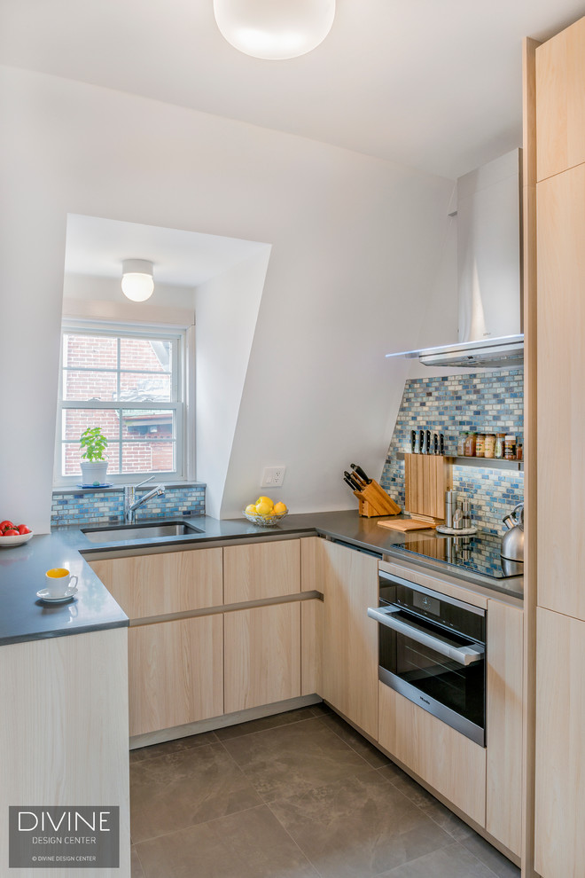 Small contemporary u-shaped kitchen/diner in Boston with a submerged sink, flat-panel cabinets, light wood cabinets, engineered stone countertops, multi-coloured splashback, mosaic tiled splashback, stainless steel appliances, slate flooring, a breakfast bar and multi-coloured floors.