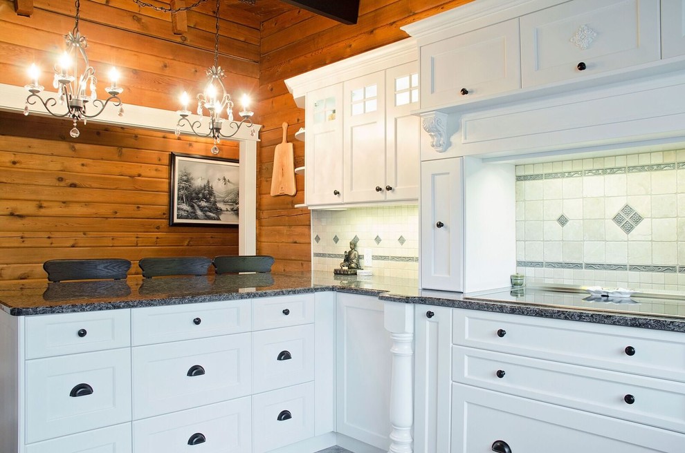 Photo of a large farmhouse kitchen in Vancouver with a submerged sink, shaker cabinets, white cabinets, beige splashback, stone tiled splashback, stainless steel appliances, ceramic flooring, a breakfast bar and brown floors.