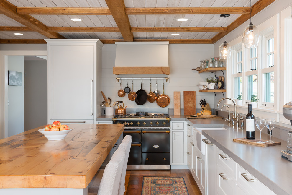Kitchen - cottage kitchen idea in Burlington with a farmhouse sink, shaker cabinets and an island