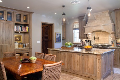 Warm and grey kitchen, cabinets, and wood table with five chairs  