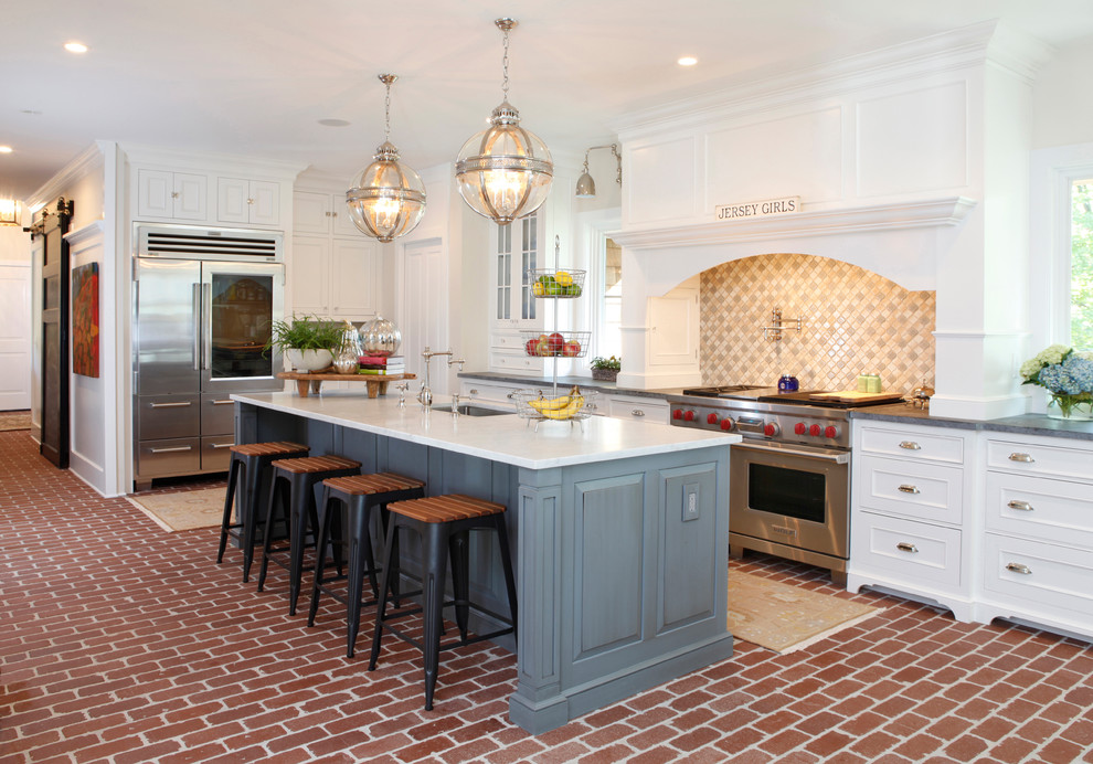 Inspiration for a timeless l-shaped brick floor and red floor kitchen remodel in Philadelphia with an undermount sink, recessed-panel cabinets, white cabinets, beige backsplash, stainless steel appliances, an island and gray countertops