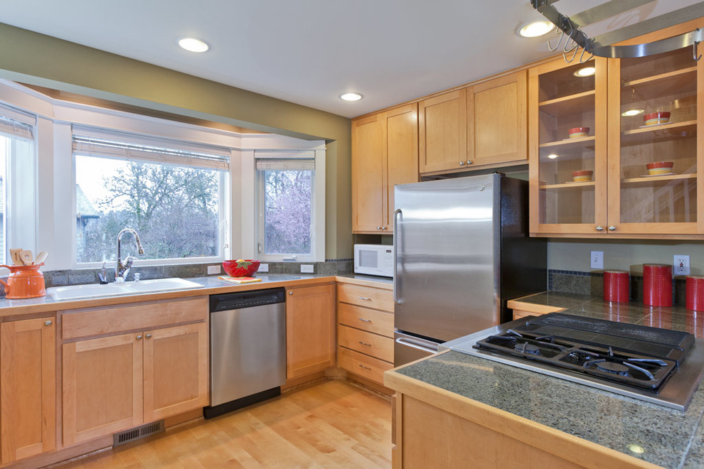 Inspiration for a transitional kitchen remodel in Seattle with a drop-in sink, shaker cabinets, medium tone wood cabinets and stainless steel appliances
