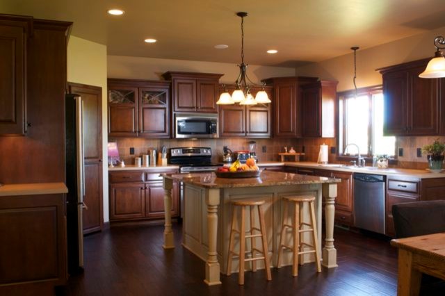 Kitchen - traditional dark wood floor kitchen idea in Other with a double-bowl sink, raised-panel cabinets, medium tone wood cabinets, granite countertops, multicolored backsplash, ceramic backsplash, stainless steel appliances and an island