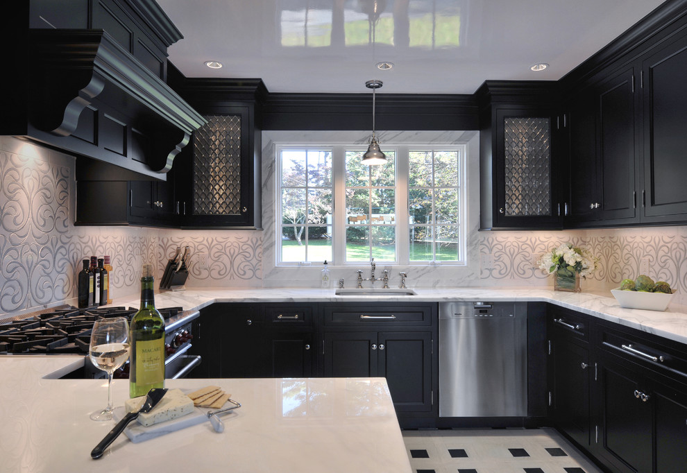 Inspiration for a contemporary u-shaped kitchen remodel in New York with an integrated sink, beaded inset cabinets, dark wood cabinets, marble countertops, white backsplash, mosaic tile backsplash, stainless steel appliances and no island