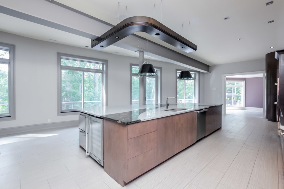 This is an example of an expansive urban l-shaped kitchen/diner in DC Metro with a submerged sink, flat-panel cabinets, medium wood cabinets, granite worktops, white splashback, stone slab splashback, stainless steel appliances, ceramic flooring and an island.