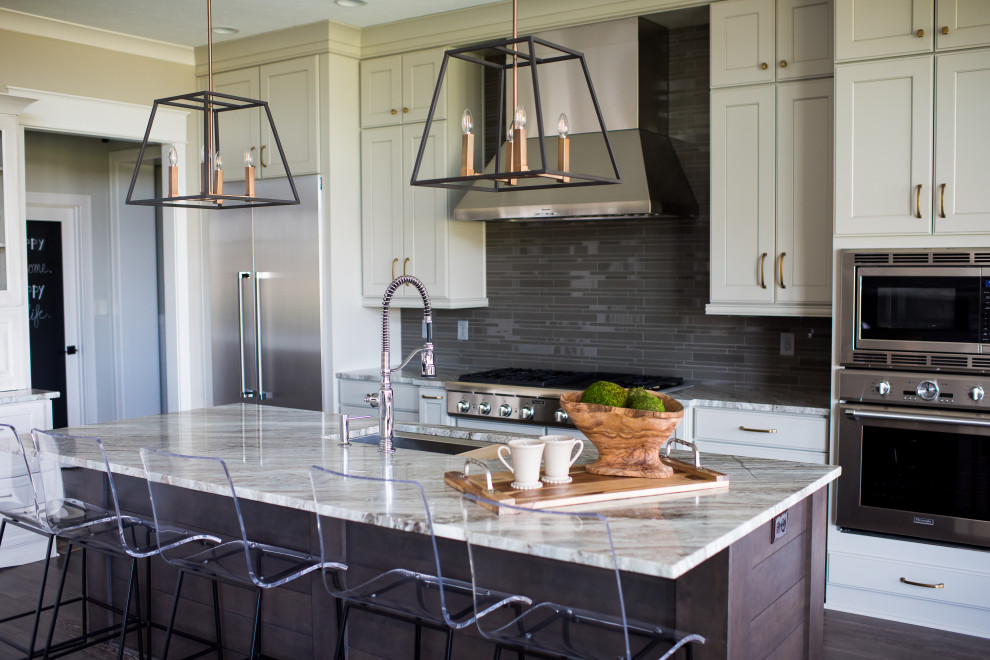 Inspiration for a mid-sized contemporary galley dark wood floor open concept kitchen remodel in Indianapolis with an undermount sink, shaker cabinets, white cabinets, granite countertops, black backsplash, subway tile backsplash, stainless steel appliances and an island