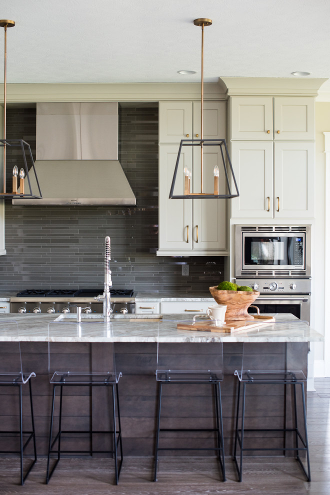 Mid-sized trendy galley dark wood floor open concept kitchen photo in Indianapolis with an undermount sink, shaker cabinets, white cabinets, granite countertops, black backsplash, subway tile backsplash, stainless steel appliances and an island