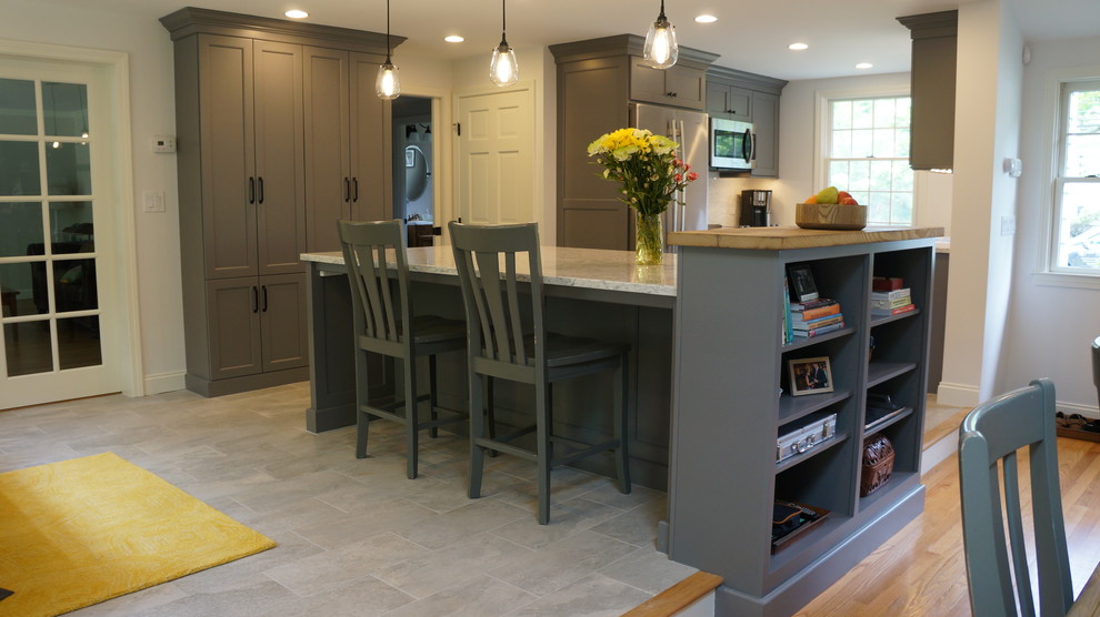 Small farmhouse galley porcelain tile and gray floor open concept kitchen photo in Boston with a farmhouse sink, shaker cabinets, gray cabinets, quartz countertops, white backsplash, matchstick tile backsplash, stainless steel appliances, an island and yellow countertops