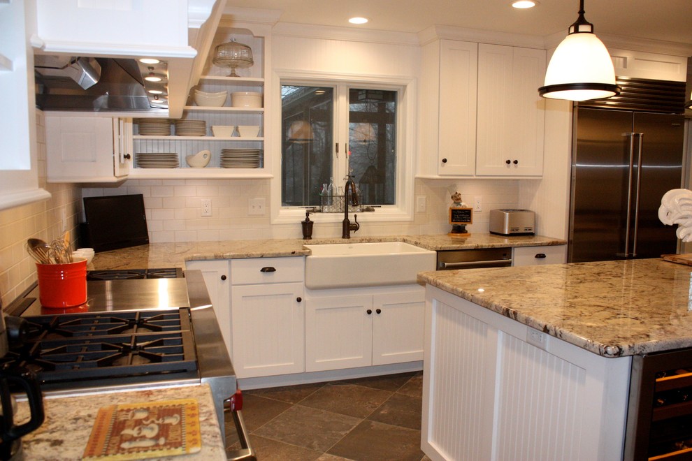 Large country u-shaped eat-in kitchen photo in Other with shaker cabinets, white cabinets, white backsplash, stainless steel appliances and an island