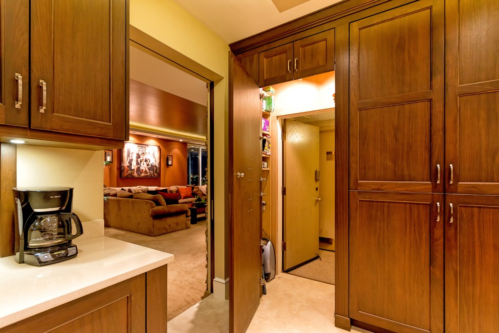 This is an example of a large traditional kitchen in Vancouver with shaker cabinets, dark wood cabinets, engineered stone countertops and porcelain flooring.