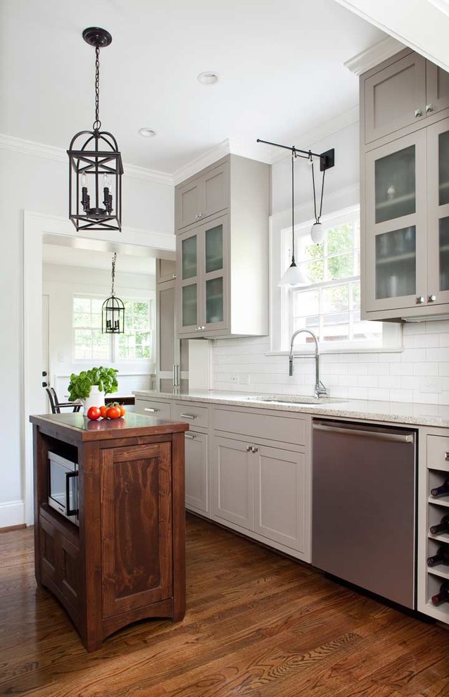 Mid-sized elegant galley medium tone wood floor eat-in kitchen photo in Atlanta with an undermount sink, shaker cabinets, gray cabinets, granite countertops, white backsplash, subway tile backsplash, stainless steel appliances and an island