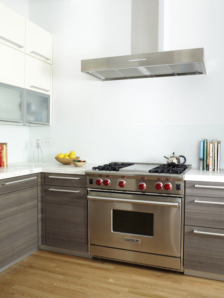 Idée de décoration pour une cuisine design avec des portes de placard grises et plan de travail en marbre.