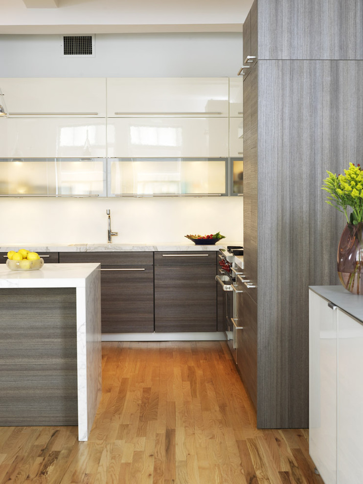 Kitchen - contemporary kitchen idea in New York with glass-front cabinets, gray cabinets and marble countertops