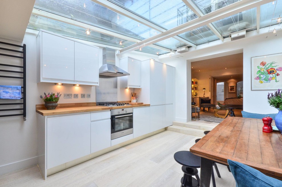 This is an example of a medium sized contemporary single-wall kitchen/diner in London with no island.