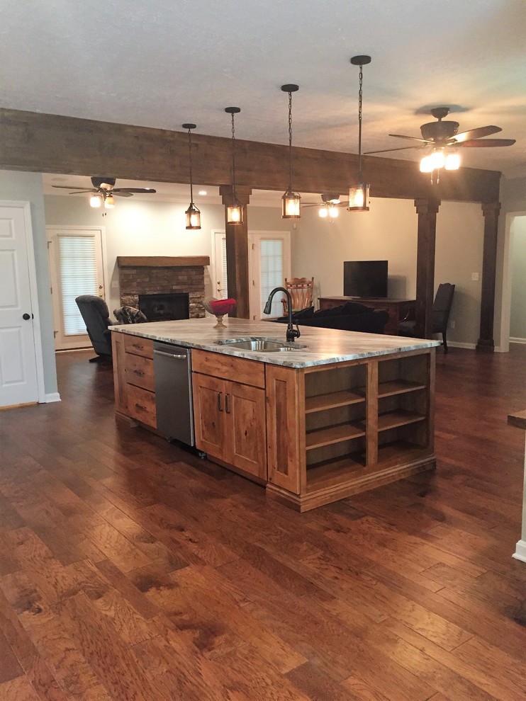 This is an example of a large rustic l-shaped open plan kitchen in Nashville with a submerged sink, shaker cabinets, medium wood cabinets, quartz worktops, grey splashback, stone tiled splashback, stainless steel appliances, medium hardwood flooring, an island and brown floors.