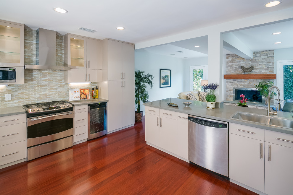 Example of a mid-sized trendy bamboo floor kitchen design in Los Angeles with a double-bowl sink, flat-panel cabinets, gray cabinets, quartz countertops, multicolored backsplash, mosaic tile backsplash and stainless steel appliances